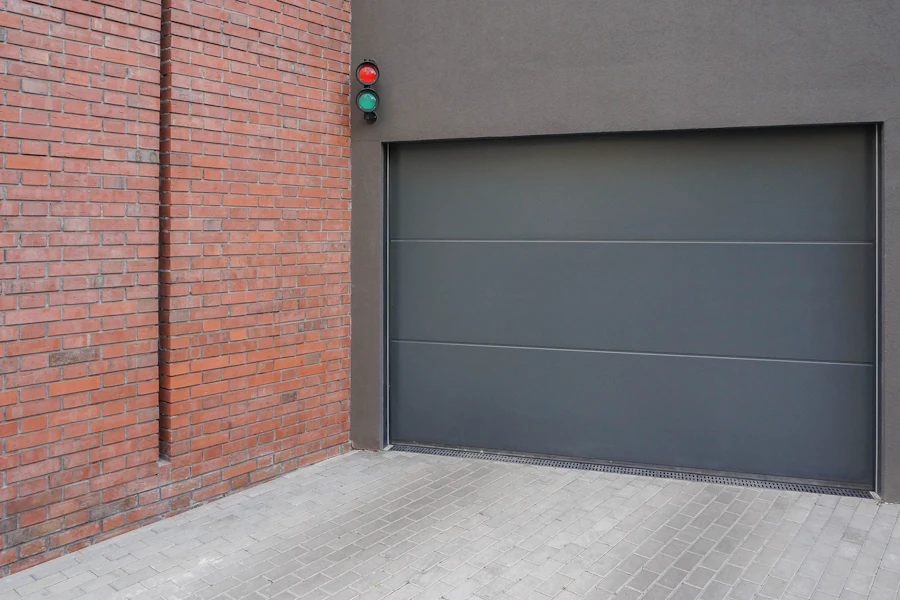 Grey garage door beside a brick wall